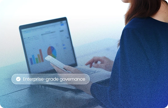 Person using laptop with data visualization dashboard — enterprise-grade governance